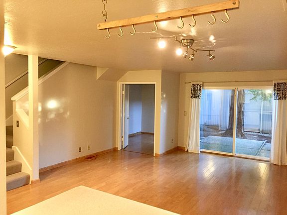 Living room - small downstairs bedroom and patio in distance.