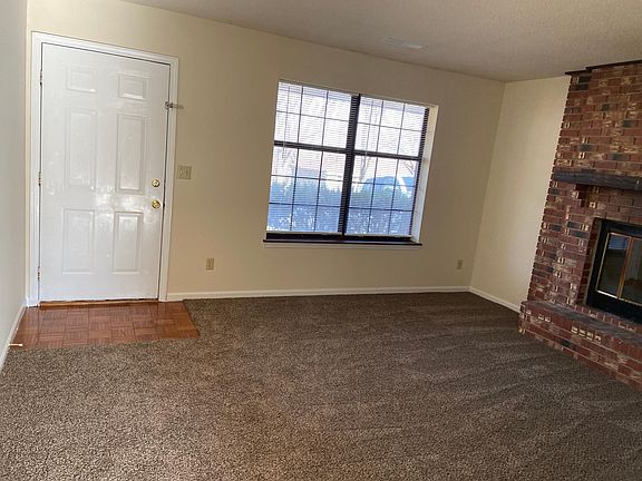 Living room area is open and sunlight filled.