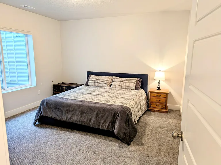 Lower-level bedroom with king-sized bed.