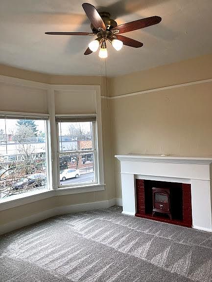 High ceilings, plenty of natural light, ceiling fan, fireplace with electric heater