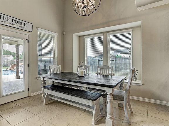 The breakfast room is located off of the kitchen and has great views of the backyard oasis.