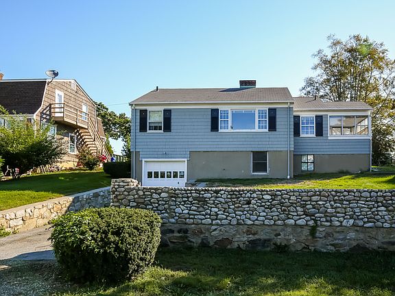 Rear of the home with the beautiful stone wall