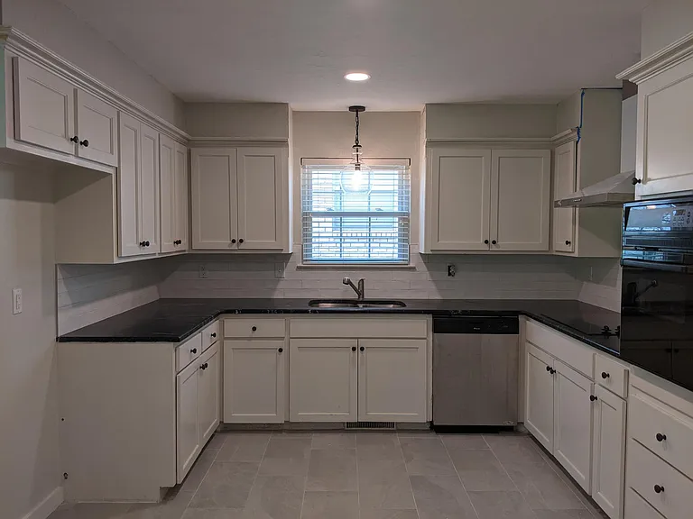 Updated bright kitchen with subway tile, new granite, and stainless and black appliances