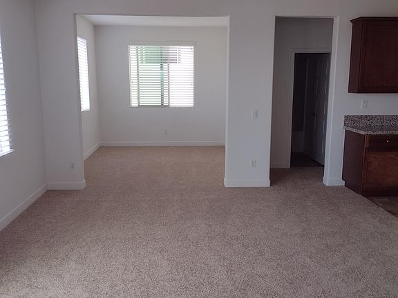 Area in front of kitchen and view of bonus room
