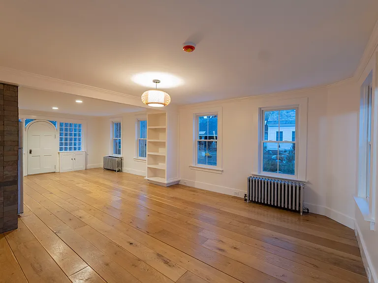 Stepping through the double glass doors finds you in the main living space, with a lot of natural light. The space has been fully renovated and is clean and bright.