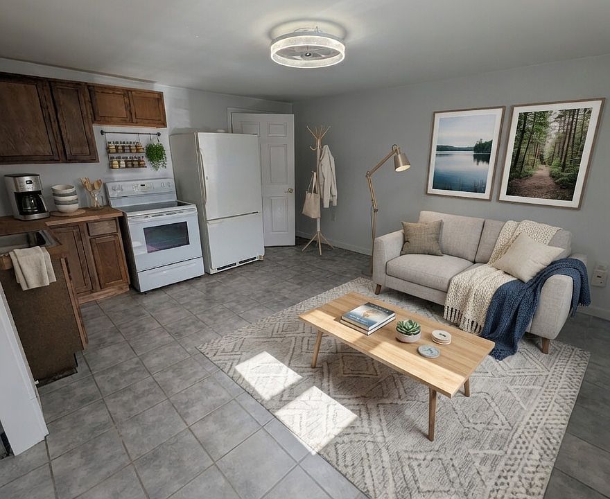 Living Room and Kitchen- this image is virtually staged to show room potential