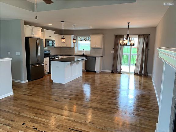 Open kitchen and dining areas with deck right outside the door.