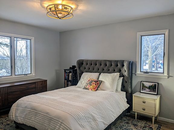Bedroom #1 is spacious with 2 windows and a big closet. Plus, a lovely fandelier.