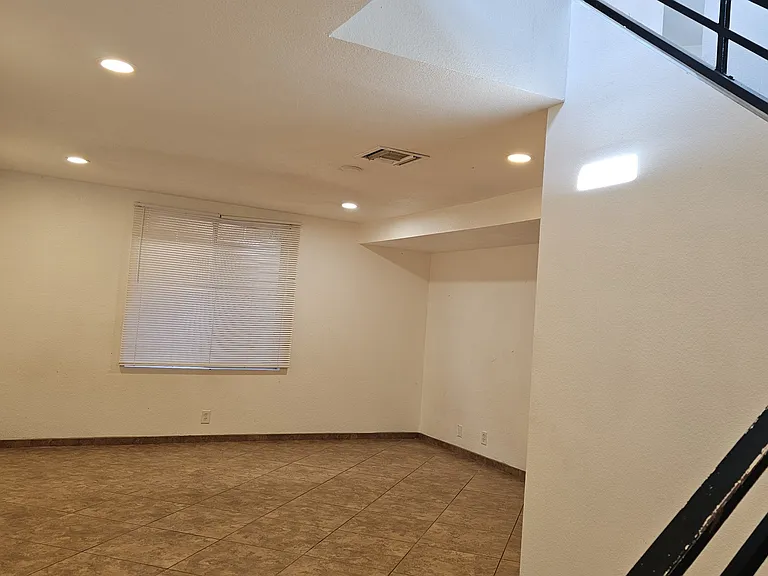 Spacious lower-level living area offering a versatile layout, perfect for a second living room, entertainment space, or additional private retreat.