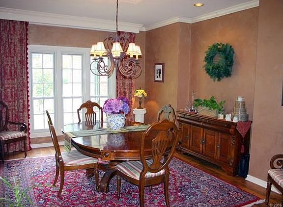 The formal dining room has plenty of space for entertaining and a great view of the front yard.  Pretty custom paint.