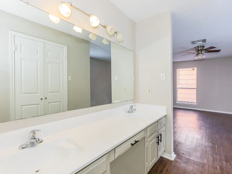 His/Hers vanity restroom in master bedroom to Townhome