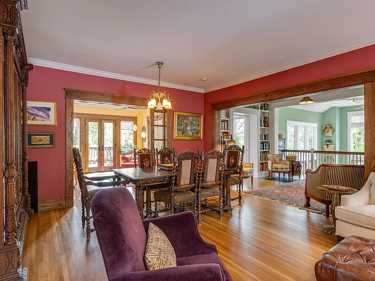 Formal dining area with detailed trim, and open flow to adjoining rooms.