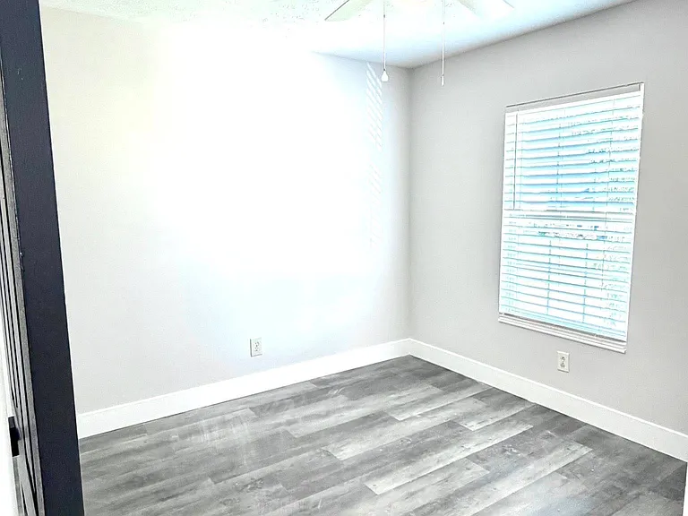 Bright and airy secondary bedroom with ceiling fan
