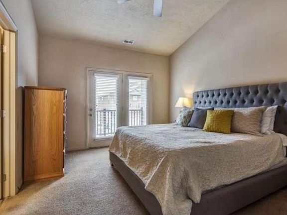 Vaulted ceilings and ceiling fans in the master bedroom.