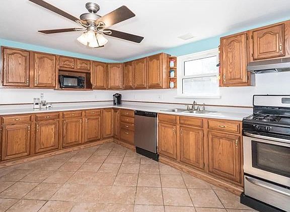 Large kitchen with plenty of cabinets and stainless appliances.