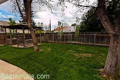 Trellised backyard dining patio with partial kitchen