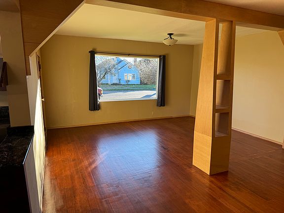 Large living room with traditional touches such refinished fir floors and builts.