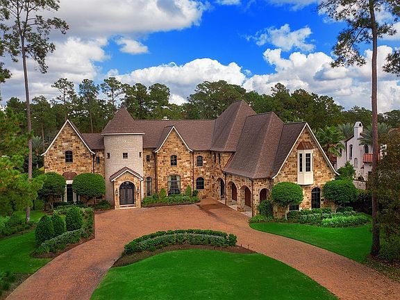 The oversized, three bay, attached garage area is located off the circular driveway and manicured grounds, and has individual side entries to remain almost imperceptible from the view of the impressive front elevation.