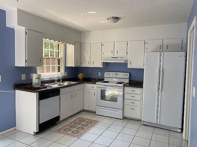Light and Bright Kitchen with sliding glass doors to deck.