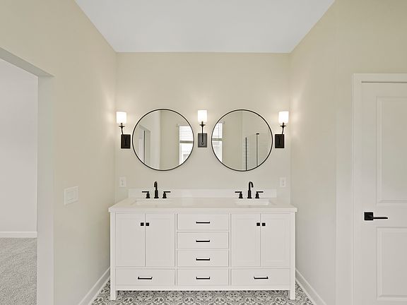 Primary bath featuring freestanding vanity with dual sinks