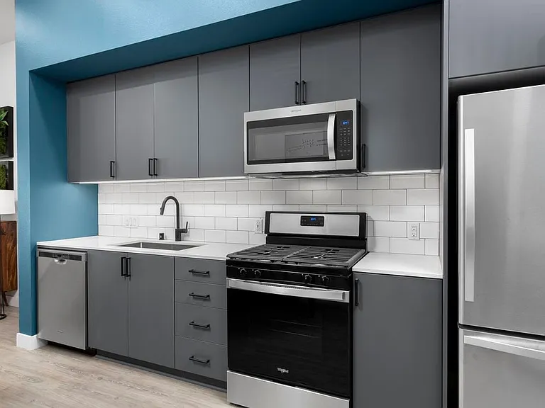 Building B Urban Design kitchen with quartz countertops, backsplash and stainless steel appliances