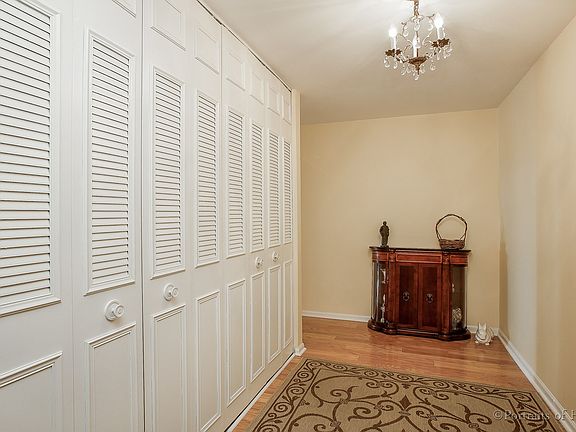 Large foyer with a wall of closets