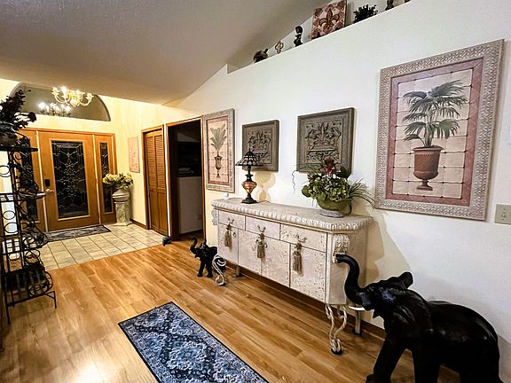 night view of front door and hallway entrance to 1st bedroom and 1st bathroom to the right