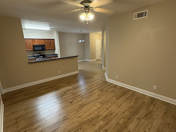 Dining area with brand new wood laminate flooring looking towards kitchen.