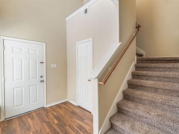 Half bath for guest, bay window for natural lighting, stairs leading up to computer niche..