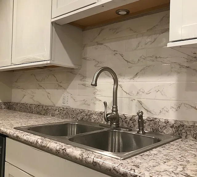You have to see this counter top and tiled backsplash to appreciate it's beauty. Under cabinet lighting is an additional feature.