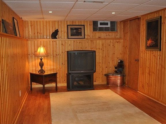   Partially finished basment, knotty pine walls & laminate floor. 