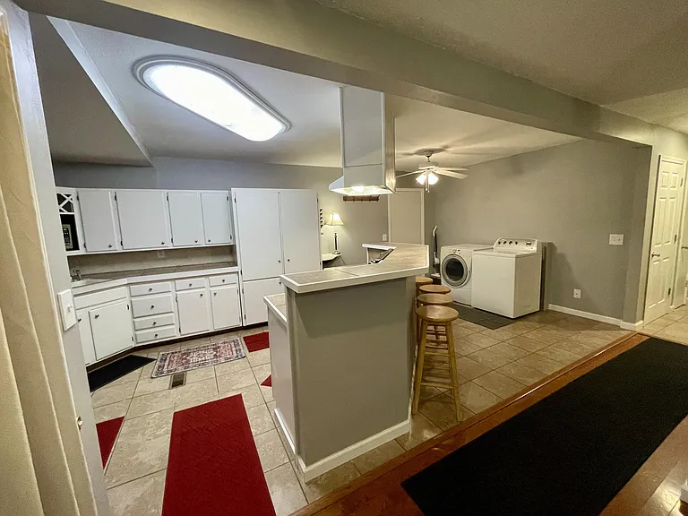 Kitchen, with island and bar seating, Laundry area