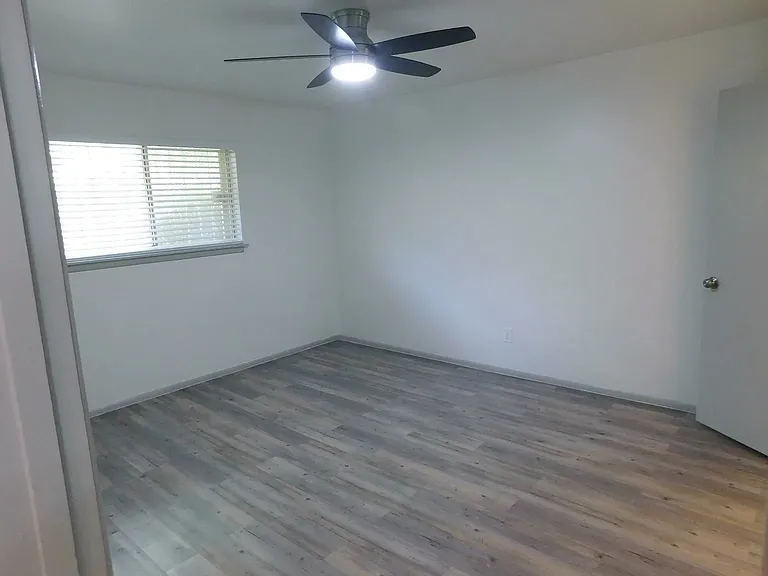 Second bedroom with one-half bath with stack washer and dryer, and walk-in closet.