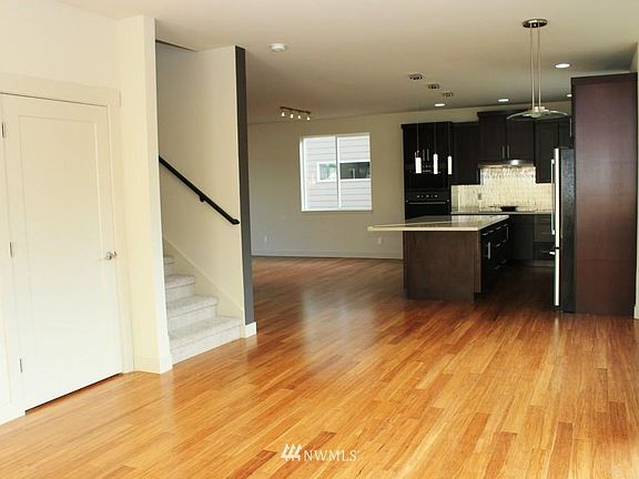 Right side (Family Room Space) of the Main Unit - Main Level looking at the Kitchen with an extra large island and a dining nook to the right