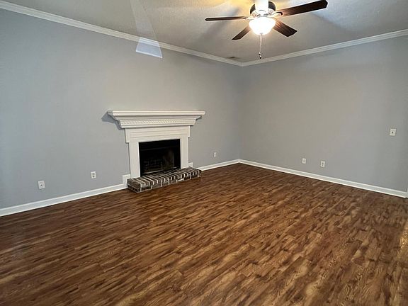 Living Room open to dining area with wood-burning fireplace