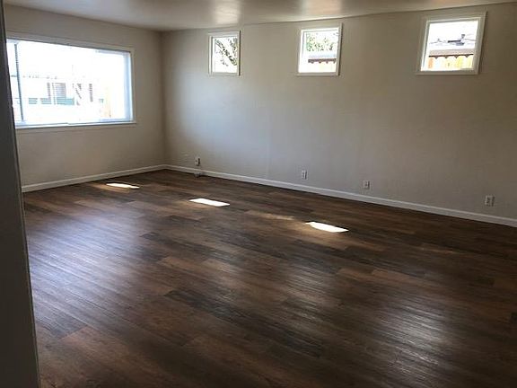Sunny family room with new flooring, lots of windows to let the light in.