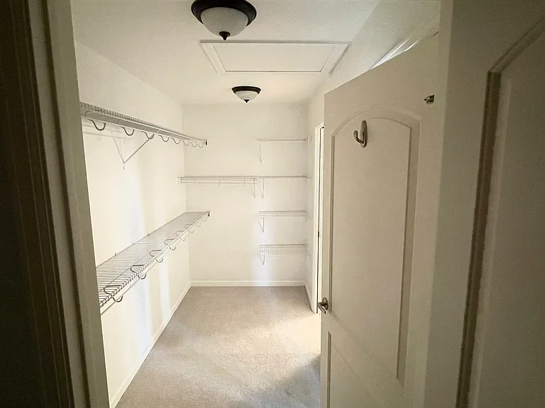 Bonus storage space looking toward large primary bedroom closet