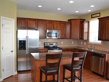 Kitchen with stainless appliances and cherry cabinets