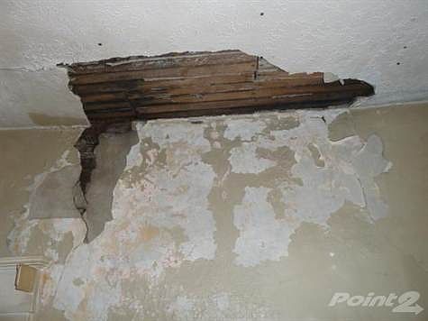 This is the damage above the fireplace in the living room ceiling. It's assumed but uncertain the damage may have been the result of a leak. It appears to be pretty much confined to this area.  We haven't seen the area above the leak in the attic.