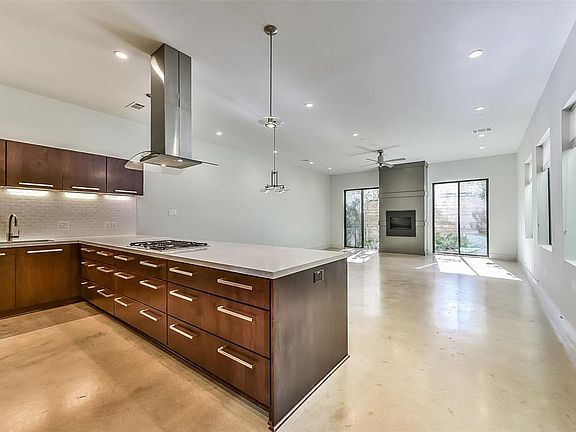 Expansive view of the living/dining areas from the sleek kitchen.