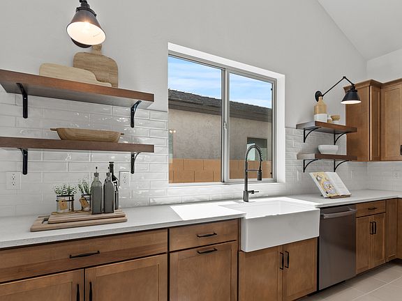 White artisan tile backsplash and floating shelves