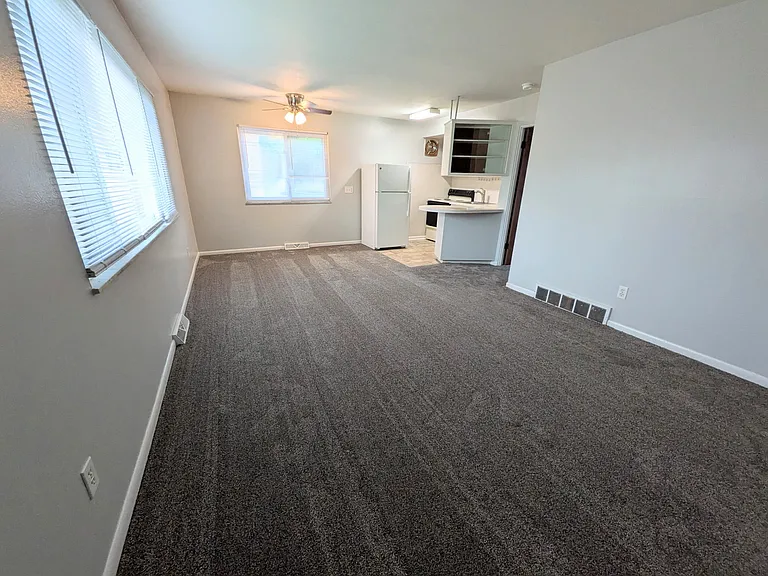 Living room and kitchen. New carpet and paint
