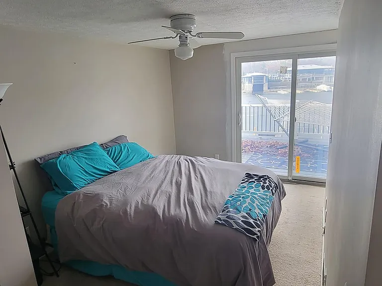 Master with sliding glass door to large trex balcony overlooking the water
