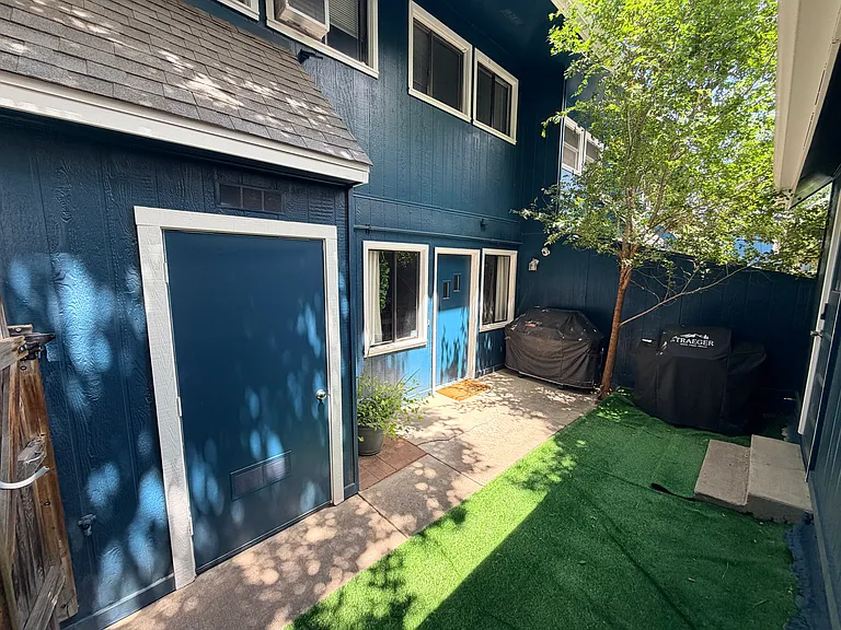 Fenced patio/yard between garage and front entry way.