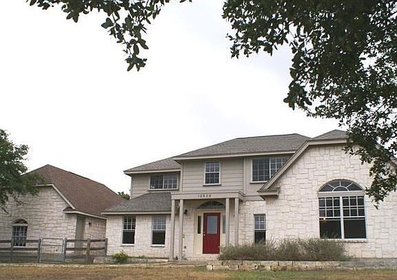 Front view of home and 3 car garage