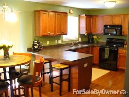 Large Eat-in Kitchen
						:
						Kitchen with cherry hardwood cabinets and floors, opens to the family room,