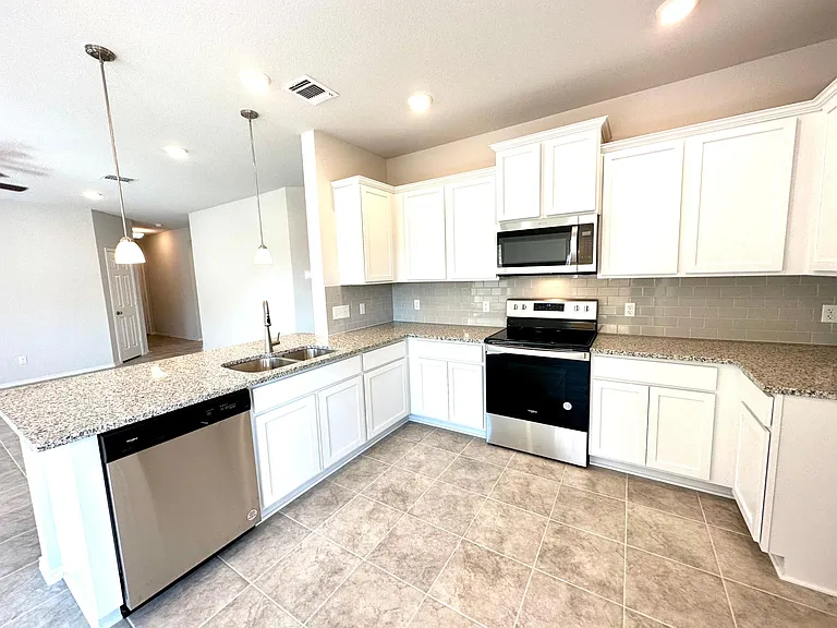 State of the art Stainless Steel appliances with downlight from microwave.