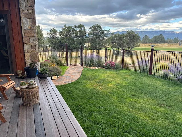 Fenced yard with gate to golf course