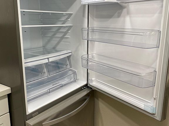 Large STAINLESS STEEL bottom-freezer refrigerator.