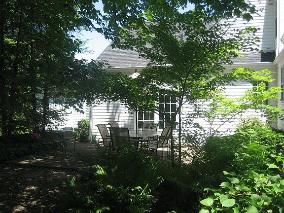 Patio w/shed & house in background